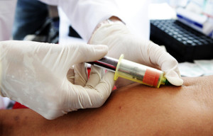 A nurse takes blood for a free HIV test on the National Day of HIV-AIDS testing in San Salvador
